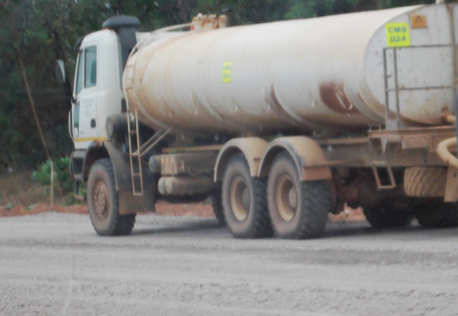 The Copperfield Mining Services Contractor’s Water Bouzer busy watering the tarring materials for their proper fixing as part of the process in the tarring undertaking of part of the 79 kilometer pedicle road.