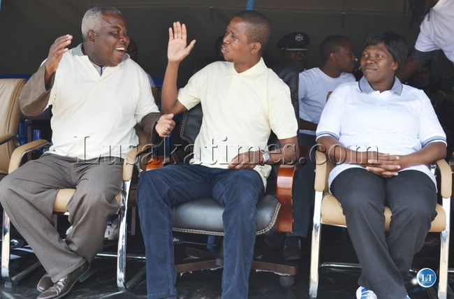 SWEET victory! Home Affairs minister Edgar Lungu (middle) and Gender deputy minister Freedom Sikazwe (left) celebrate the Patriotic Front's victory in the Mansa Central by-elections as Inspector General of Police Stella Libongani looks on. This was during the launch of the I Care About her campaign in Chawama on Saturday.