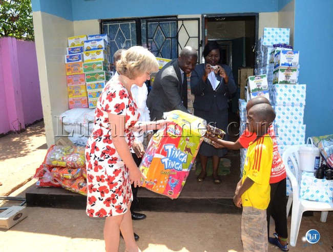 VICE President's wife Charlotte Scott and Zambia Association of Manufacturers (ZAM) CEO Maybin Nsupila hands over goods donated by ZAM to Chilenje Transit Home in Lusaka