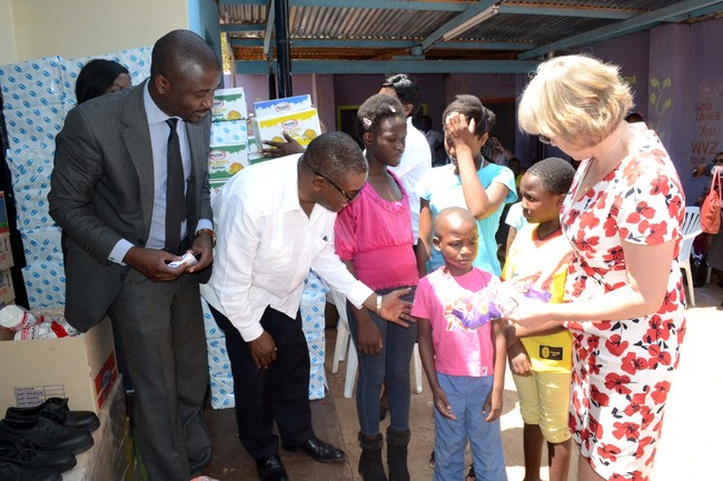 Vice President's wife Charlotte Scott, Zambia Association of Manufacturers (ZAM) CEO Maybin Nsupila ponder what to do as the little boy from Chilenje trnsit home looks unimpressed with the goods donated by ZAM to the Chilenje Transit Home