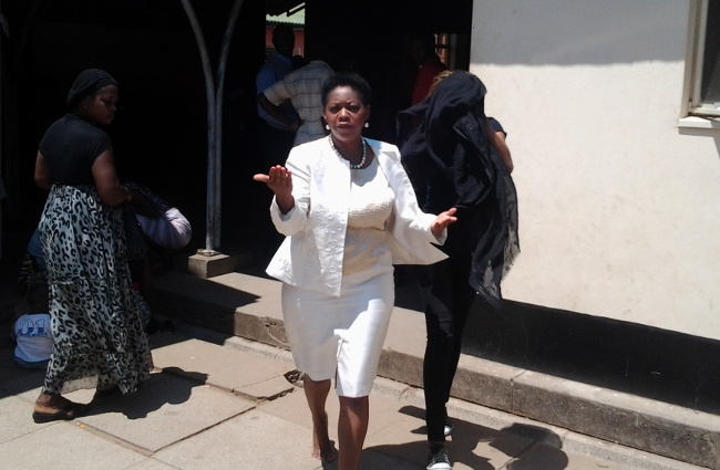Mrs Zimba charges at cameraman outside court