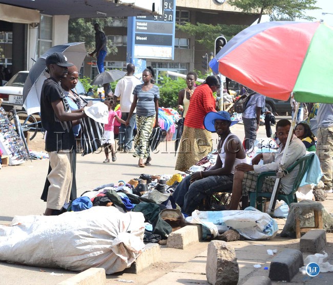 SALAULA (Second hand clothes) has become the main business on the streets. Above, people selecting different clothing along Lumumba road in Lusaka