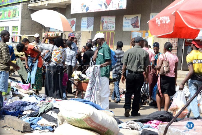 Salaula (Second hand clothes) has become the main business on the streets. Above, people selecting different clothing along Lumumba road in Lusaka