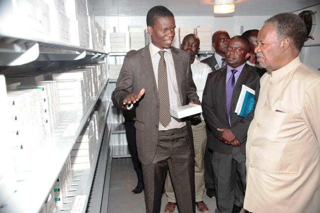 President Michael Sata listens to Mr Abraham Mwanamwenge the World Health Organisation logistics Advisor after officialy commissioning the provincial vaccine store in Mansa