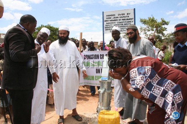 Deputy minister of community development mother and child health drinks water from the borehole donated by the muslim social and welfare trust