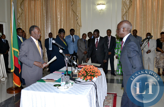 President Michael Sata receives an affidavit from newly appointed Ambassador Designate to Egypt Ali Simwinga during the swearing in ceremony at State House today