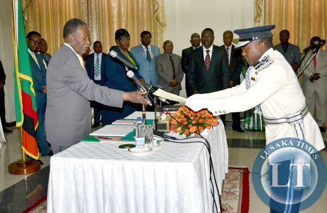 President Michael Sata receives an affidavit from newly appointed Commissioner to Police at State House Godwin Phiri during the swearing in ceremony at State House