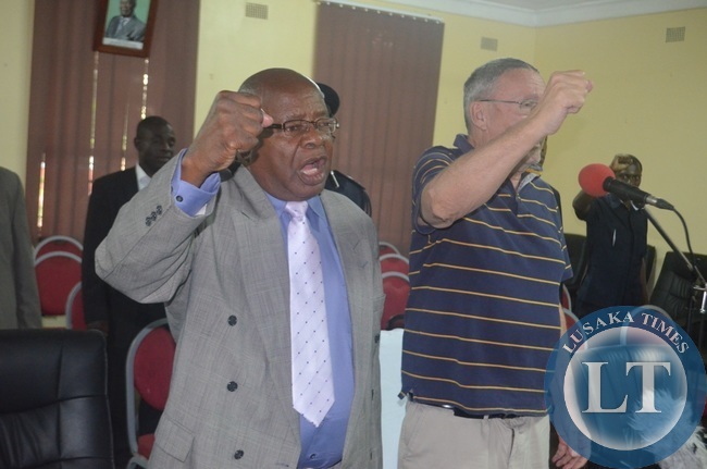 Vice President Guy Scott (right)) and Southern Province Minister Daniel Munkombwe (left) singing the national anthem during a meeting with PF supporters at Livingstone Civic Centre Committee room on