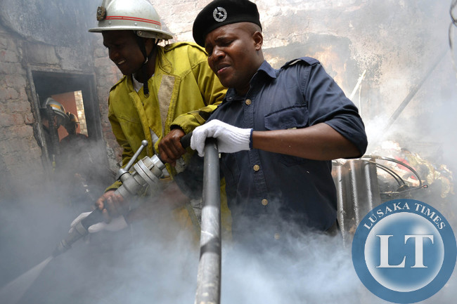 International Women's Day turned tragic for a Rhodespark family in Lusaka when a fire burned their house to ashes. Above, firefighters fight the inferno in part of the building where the roof had curved in due to the intensity of the fire