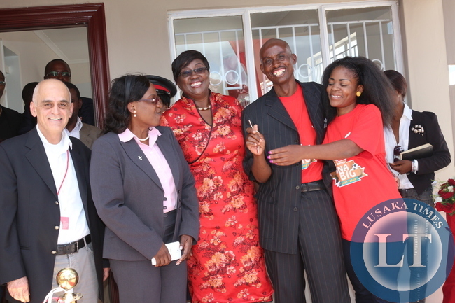 irtel Marketing Director Walid Akkaoui, Airtel CEO Charity Chanda Lumpa Minister of Local Government and Housing Emerine Kabanshi, Matero Resident Lovemore Mulenga, Jacqueline Kasonde Mulenga t the handover of the house won by Lovemore Mulenga during the ongoing "Wina Biga" promotion at the North Gate Garden