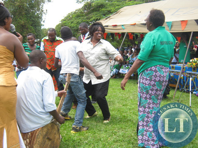 Deputy Community, Development mother and child deputy minister Jean Kapata and Central province Edwidge Mutale joining other women in dancing during the women celebrations