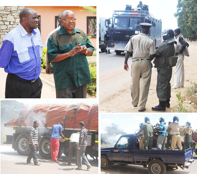 Southern Province Minister Daniel Munkombwe (in glasses) talks to Patriotic Front Mazabuka District chairperson Gift Haziba while on the right police officers in full riot gear patrol on foot while others on motor vehicles as some youths help the officers to put out fire set on a foreign truck on Mazabuka-Lusaka Road when residents rioted on Wednesday