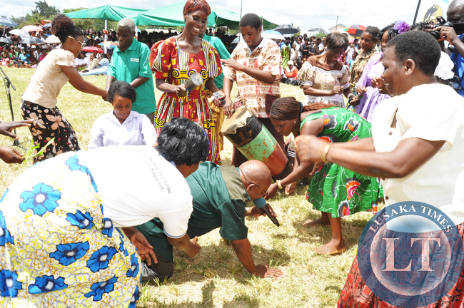 Southern Province minister Daniel Munkombwe join Mukanzuko dance troupe from Chisekese during the commemoration of the International Womens Day in Mazabuka
