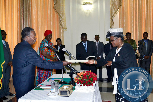 President Michael Sata receives an affidavit from newly appointed Community Development Mother and Child Deputy Minister Ingrid Mpande at State House