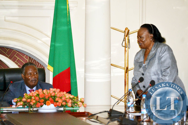 President Michael Sata listens to Acting Chief Justice Lombe Chibesakunda during the launch of the African Peer Review Mechanism report at State House in Lusaka