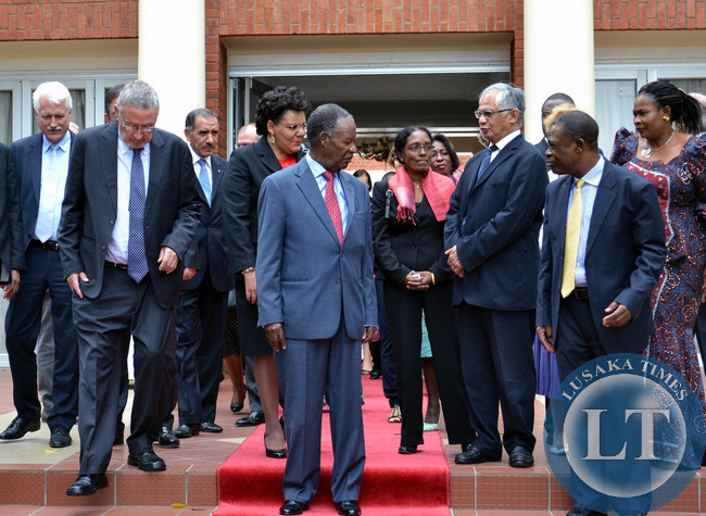 President Michael Sata, accompanied by Vice President Guy Scott (second from left), interacts with heads of diplomatic missions accredited to Zambia as Justice Minister Wynter Kabimba (second from right) looks on after a closed door meeting at State House in Lusaka