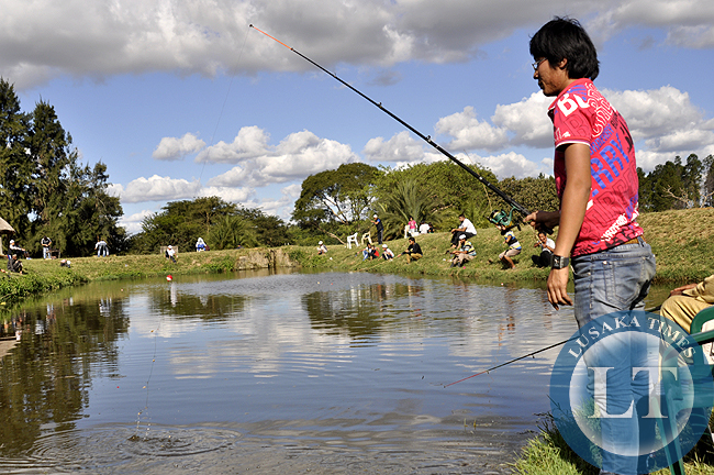 A Chinese man angling in one of the fishing ponds atKalimba Reptile Farm