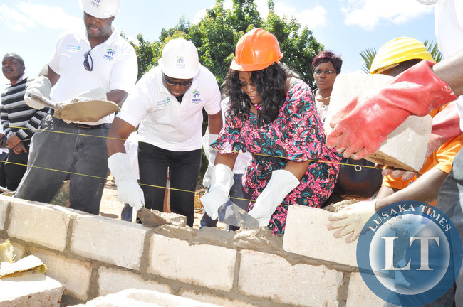 First Lady Dr Christine Kaseba with Standard Chartered Chartered Bank Chief Executive officer Andrew Okai during the Standard Chartered Bank- Habitat for Humanity Zambia builds House s for Vulnerable women in Linda Compound in Lusaka