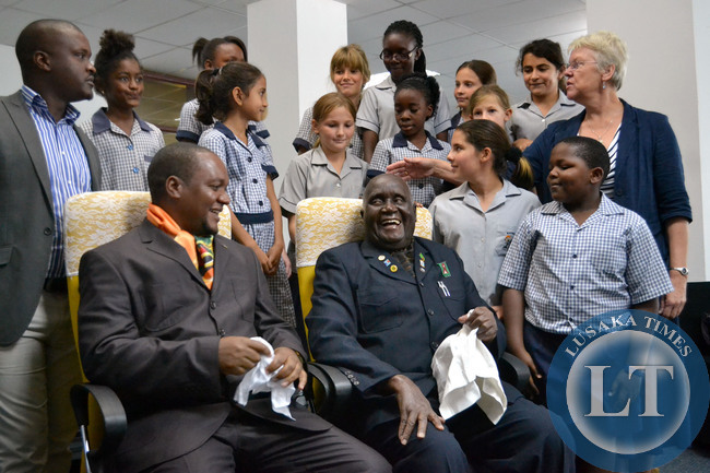 First Republican President Dr Kenneth Kaunda shares a light moment with Commerce Deputy Minister Miles Sampa who was dressed in a 'Kaunda suit' and carrying a white handkerchief like the former president at the commemoration of Dr Kaunda's birthday by school pupils at Mulungushi International Conference Centre