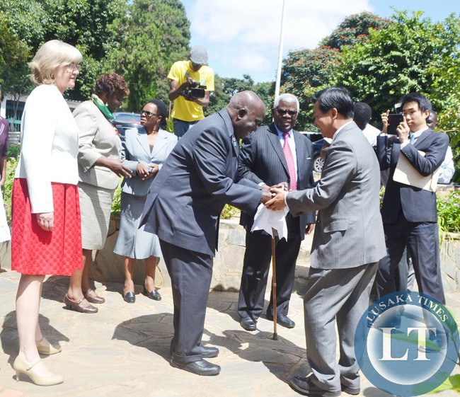 t Dr Kenneth Kaunda (centre) shakes hands with Chinese Ambassador to Zambia Zhou Yuxiao as Deputy Permanent Secretary to the Cabinet Peter Kasanda (in maroon tie and spectacles) and Vice-President Guy Scott's wife Charlotte (left) look on. This was when Dr Kaunda arrived at the launch of his 90th birthday celebrations at his office in Lusaka