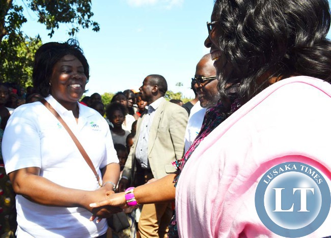 FIRST Lady Dr Christine Kaseba (right) shares a light moment with Tourism and Arts Minister Jean Kapata in Linda Township. Dr Kaseba congratulated Ms Kapata for her recent appointment.
