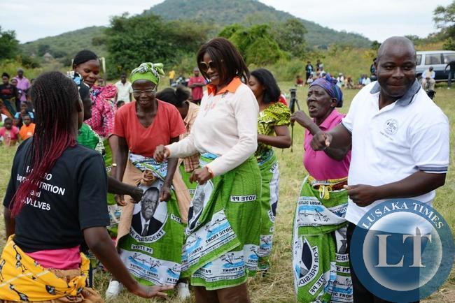 Chongwe Member of Parliament Sylvia Masebo (C) and Chongwe District council chairperson Kennedy Matabula joining the dancing group during the civil society for scaling up nutrition global day of action in at Katuba primary school