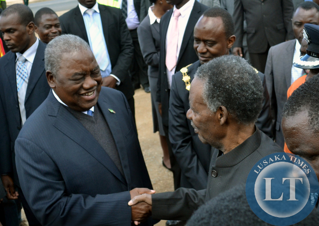 President Michael Sata shakes hands with former Republican president Rupiah Banda at the commemoration of Africa Freedom Day at the freedom statue in Lusaka