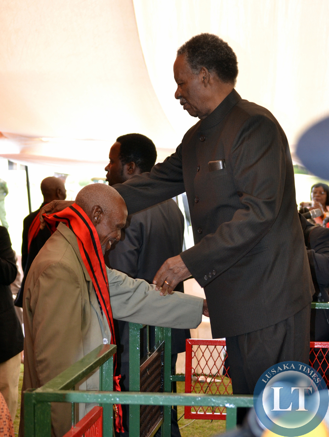 President Michael Sata honours Frank Mulenga with the Grand Commander of the Companion Order of Freedom during the investiture ceremony at State House in Lusaka