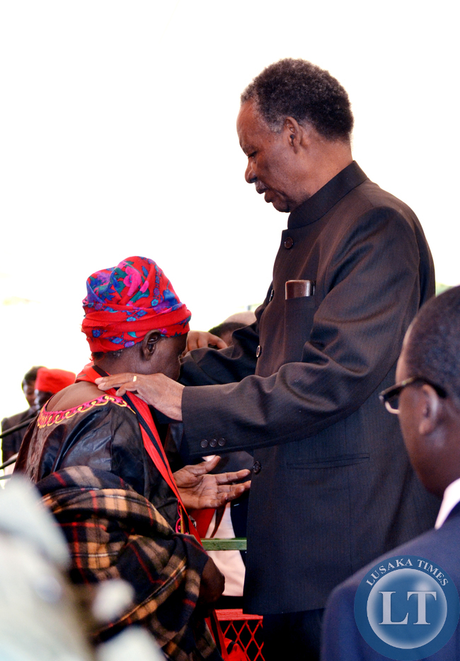 President Michael Sata honours Veronica Mumba with the Grand Commander of the Companion Order of Freedom during the investiture ceremony at State House in Lusaka