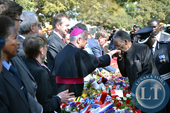 President Michael Sata kisses the hand of Vatican Ambassador to Zambia Julio Murat during the commemoration of Africa Freedom Day at the freedom statue in Lusaka.