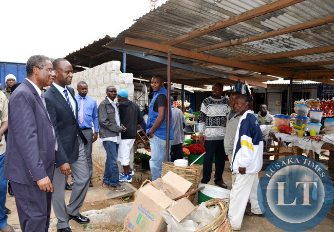 Local Government Minister Emmanuel Chenda (left) and Lusaka Mayor Mulenga Sata talk to traders at Northmead shopping centre
