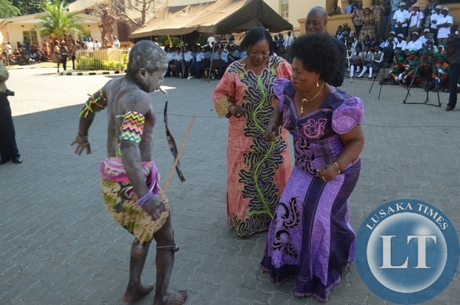 Chiefs and Traditional Affairs Minister Nkandu Luo (second fro far right), her deputy Suzan Kawandami (second from far right), Zambezi Ward councillor Philemon Musonda (far right) being entertained by a dancer (far left) from Livingstone's Tusole cultural group