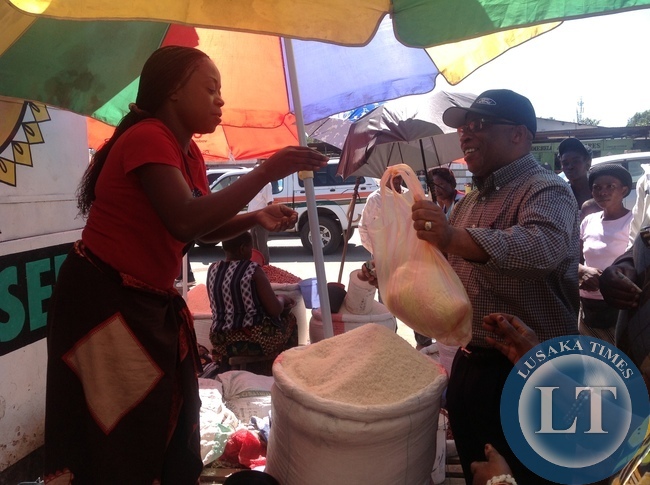 Nevers Mumba buying commodities at Chisokone market