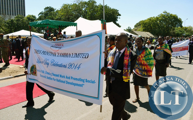 Workers from various organisations march past the saluting dais of President Michael Sata during Labour Day celebrations in Lusaka