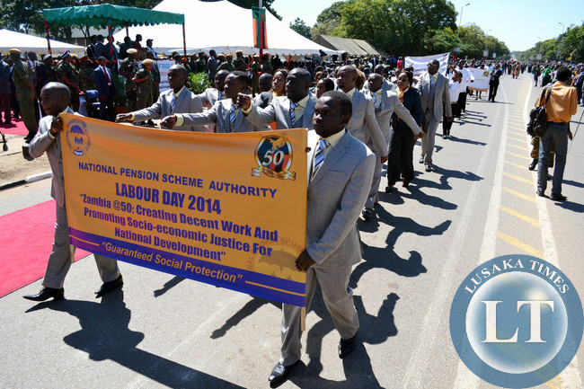 Workers from various organisations march past the saluting dais of President Michael Sata during Labour Day celebrations in Lusaka