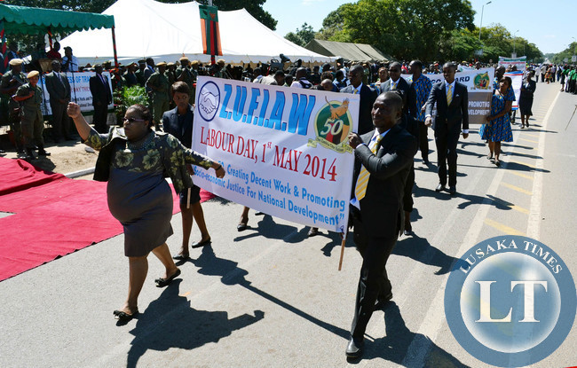 Workers from various organisations march past the saluting dais of President Michael Sata during Labour Day celebrations in Lusaka