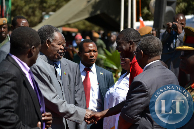 President Michael Sata is welcomed by Zambia congress of Trade Unions president Leonard Hikaumba on his arrival at the Freedom Statue for Labour Day celebrations in Lusaka
