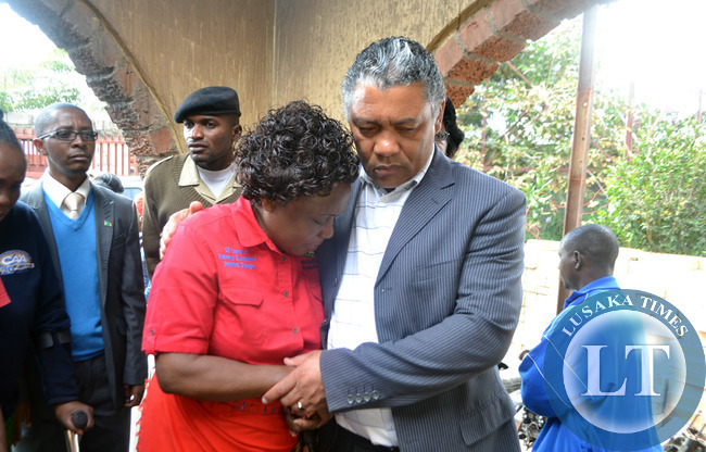 Kabwata Member of Parliament Given Lubinda consoles Chilenje ward eight councillor Maggy Zulu who was overcome with grief when the parliamentarian visited a house in Chalala township where a woman died after the structure caught fire in Lusaka recently