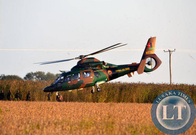 A Zambia Air Force (ZAF) helicopter takes off from the site of a fatal ZAF plane crash on York Farm on Mumbwa road