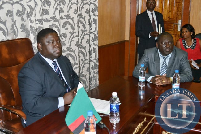 Transport, Works, Supply and Communications Minister Yamfwa Mukanga (left) addresses new Zambia Railways Board members at his office as the new Board Chairperson Davies Chama looks on in Lusaka