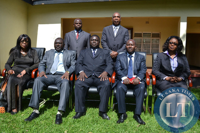 Transport, Works, Supply and Communications Minister Yamfwa Mukanga (centre) poses for a photograph with new Zambia Railways board members at his office in Lusaka