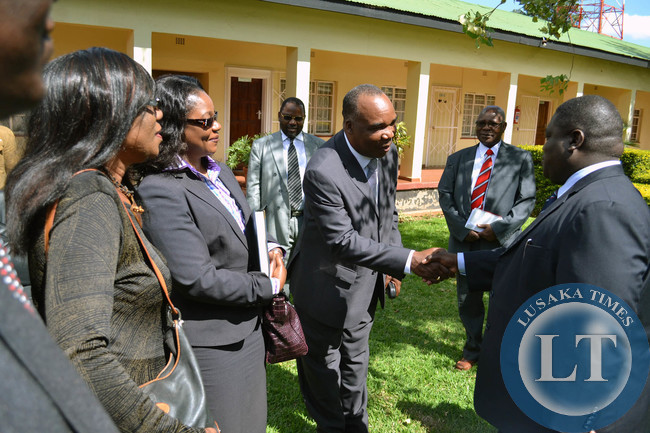 Transport, Works, Supply and Communications Minister Yamfwa Mukanga (right) shakes hands with new Zambia Railways Board Members Stephe Simukanga as others look on in Lusaka