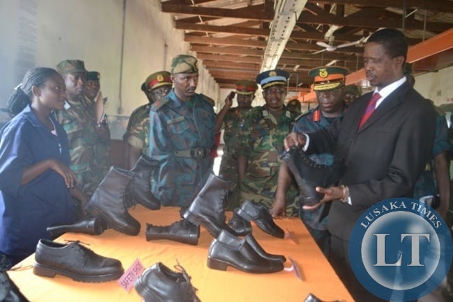 DEFENCE Minister Edgar Lungu admires a boot manufactured by youths under the Zambia National Service (ZNS) Youth Skills Training Programme in Kitwe.