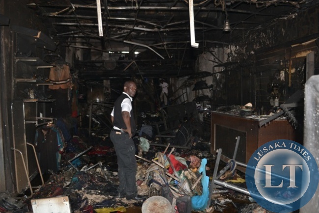 SOME employees scavenging through debris of gutted Yamaje Trading at Yemba Building Complex which was gutted by fire in Kitwe