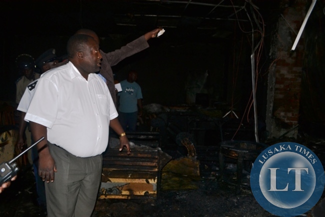 COPPERBELT Minister Mwenya Musenge inspecting extent of fire damage at Carnival Furnishers in Kitwe