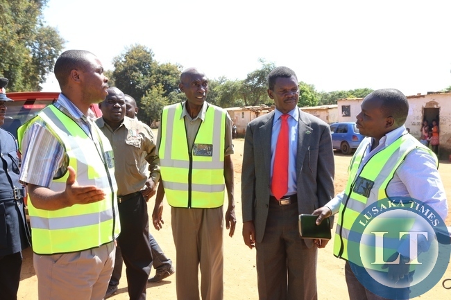 ,Lusaka Province Minister Phillip Kosamu talks to shibuyunji DC Phanwell Mweemba during the tour of roads in shibuyunji district