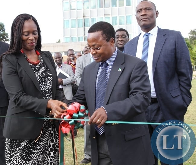 Health Permanent Secretary,Dr.Davy Chikamata exchanges documents with United Nation Development Programme Country Director, Viola Morgan when UNDP donated Six Land Cruisers and one Hilux double cap valued at US$281,750 to the Ministry of Health
