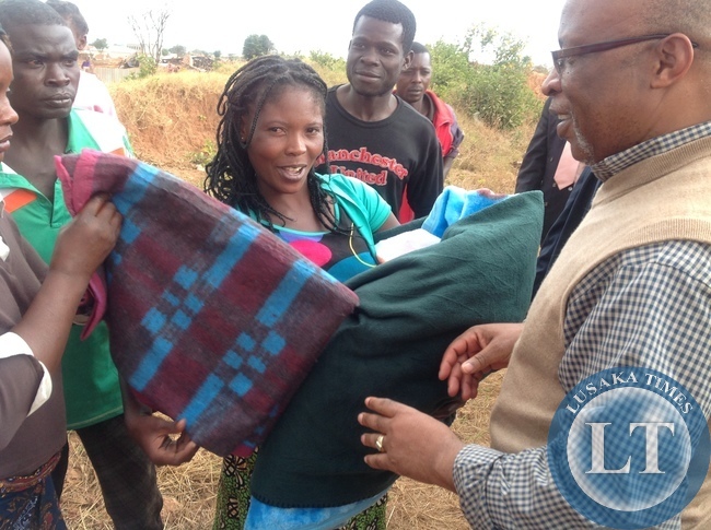 Dr Mumba hands over blankets to mothers whose houses have been demolished