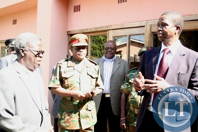 Defense Minister Edgar Lungu (r) confers with PF Western Province Chairman Kenneth Namutulo (r) as Zambia Army Secretary Brig .Gen. William Sikazwe (c) looks on during an Official visit in Mongu District at Country Lodge, Western Province