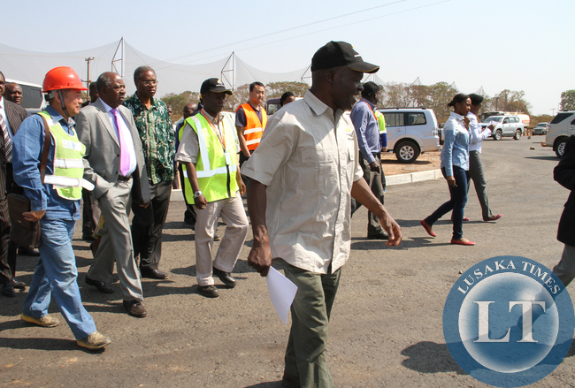 Avic International Deputy Director Liu Xiaodong (left) takes Finance Minister Alexander Chikwanda (second from left), Local Government and Housing Minister Emmanuel Chenda and Road Development Agency Director General Bernard Chiwala on an inspection of one of the roads under construction in Lusaka